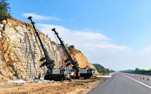 Highway rock cut with anchor drills